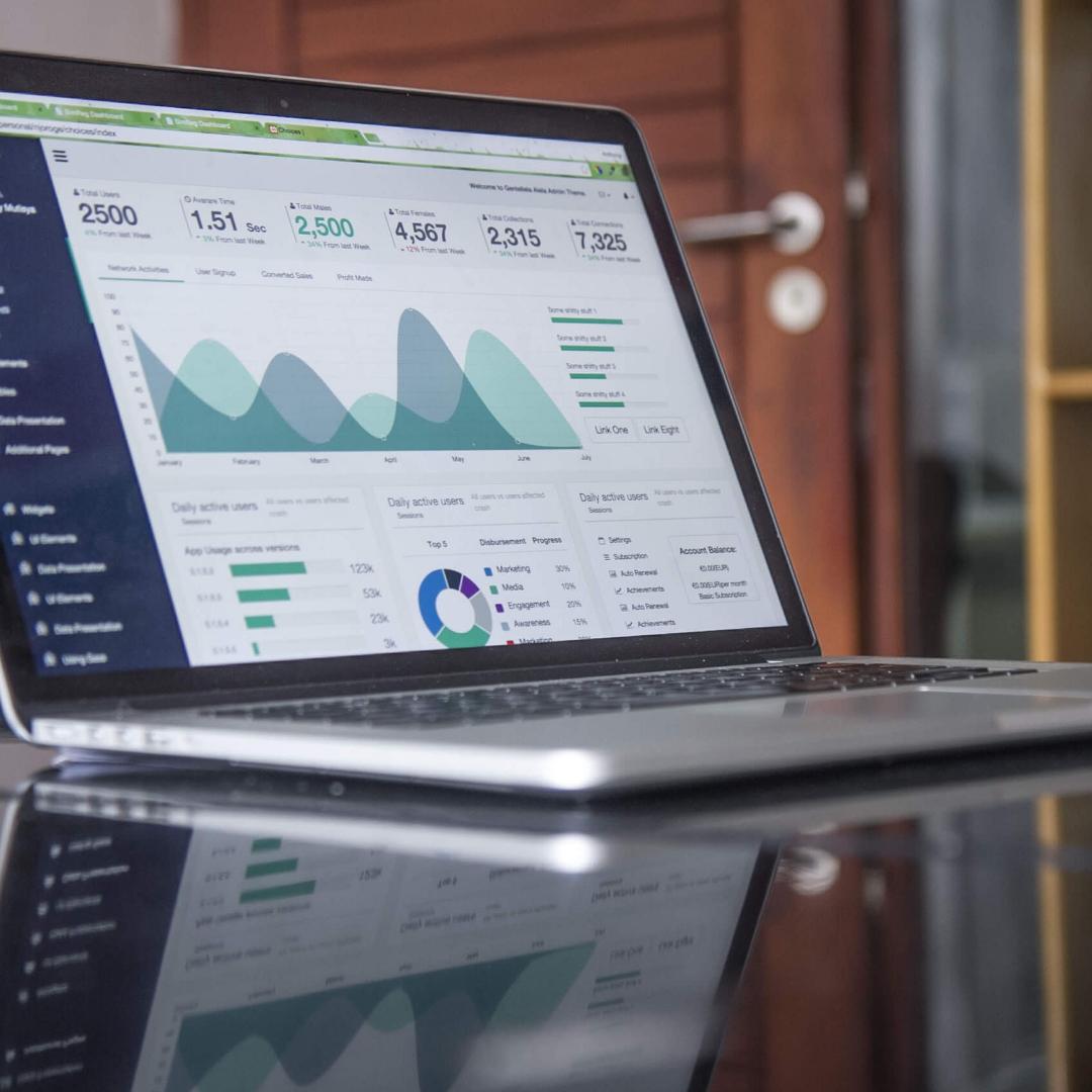 Business growth analytics dashboard on a laptop showing key performance indicators for tailored business support and investment opportunities.